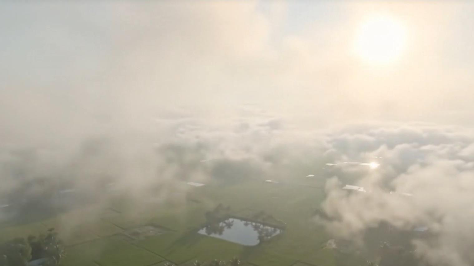 Aerial view of clouds over green fields in Bangladesh
